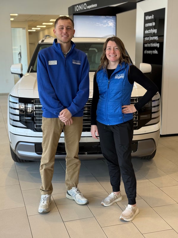 Two Moore Automotive Team members in the showroom